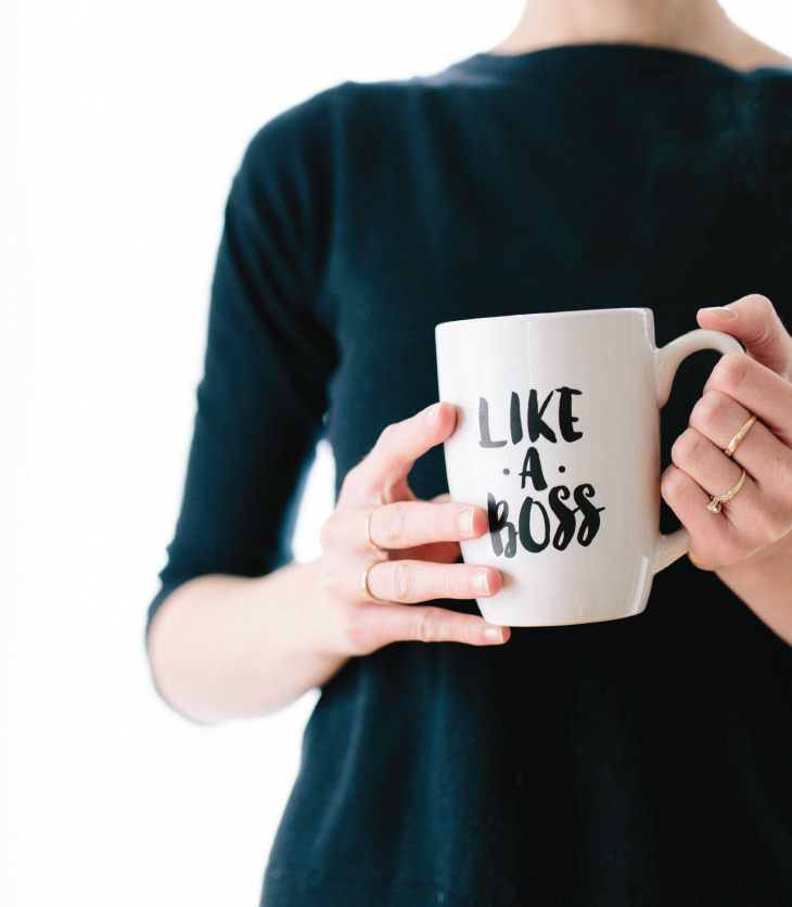 Woman Holding a Mug that Says Like a Boss